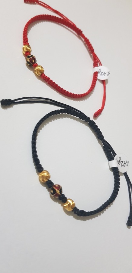 Close-up of red and black cord gold-bead bracelets from the Italgold London collection