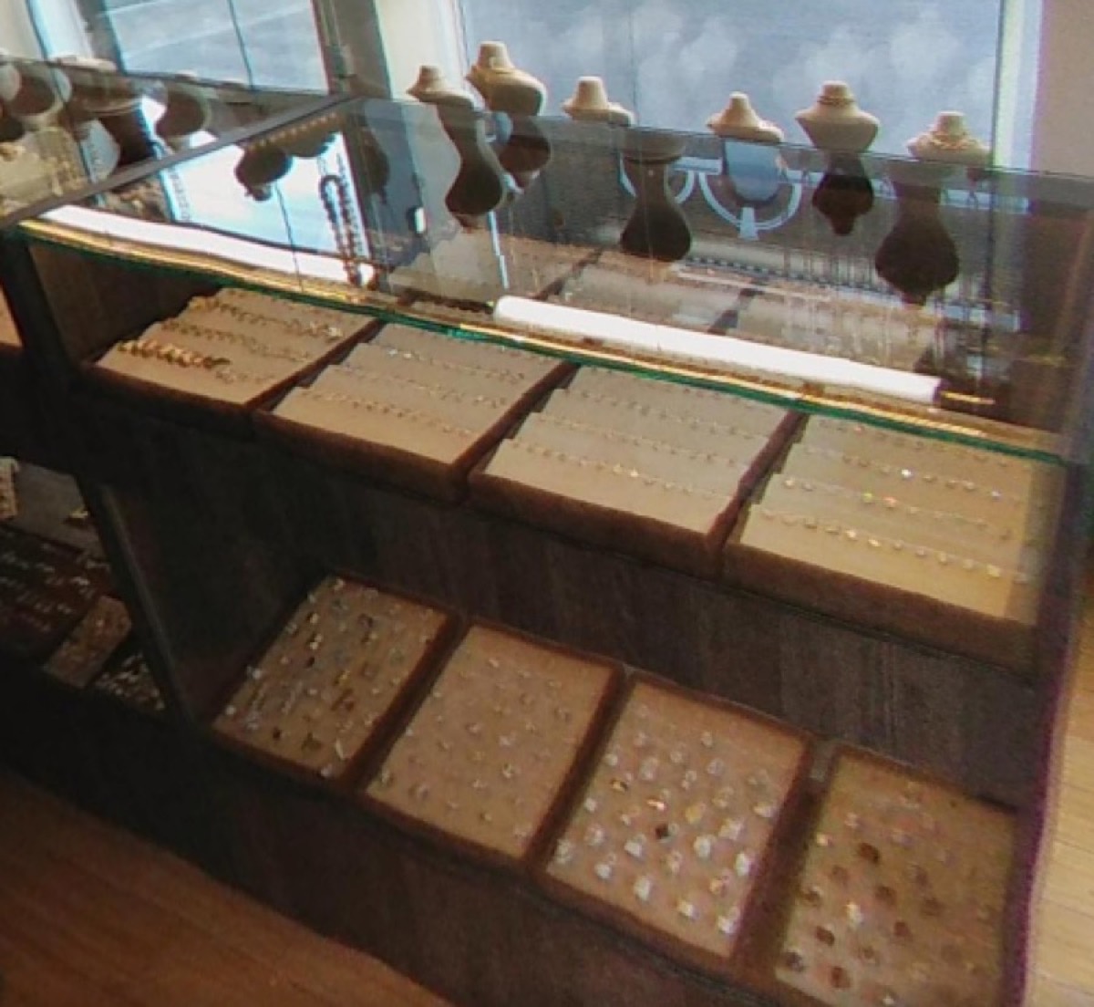Trays of gold rings and earrings in the Italgold London display cabinet